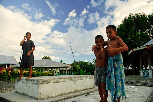 Playing on the graves, Tafua, Savai'i, Samoa.