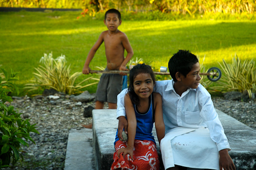 Kids on graves, Tafua, Samoa.